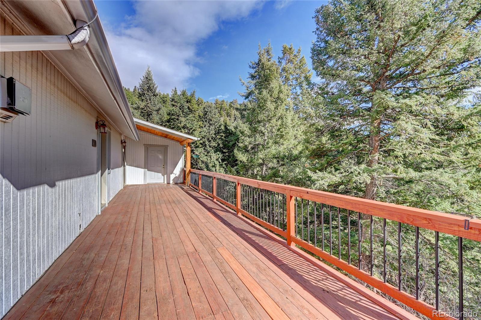 32856 Timber Ridge Road Evergreen, CO 80439 - Photo 31 of 41 a view of balcony with wooden floor and fence