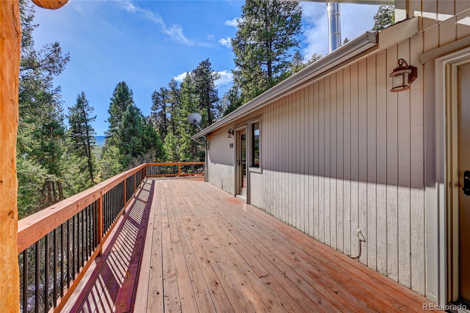 32856 Timber Ridge Road Evergreen, CO 80439 - Photo 32 of 41 a view of balcony with wooden floor and fence