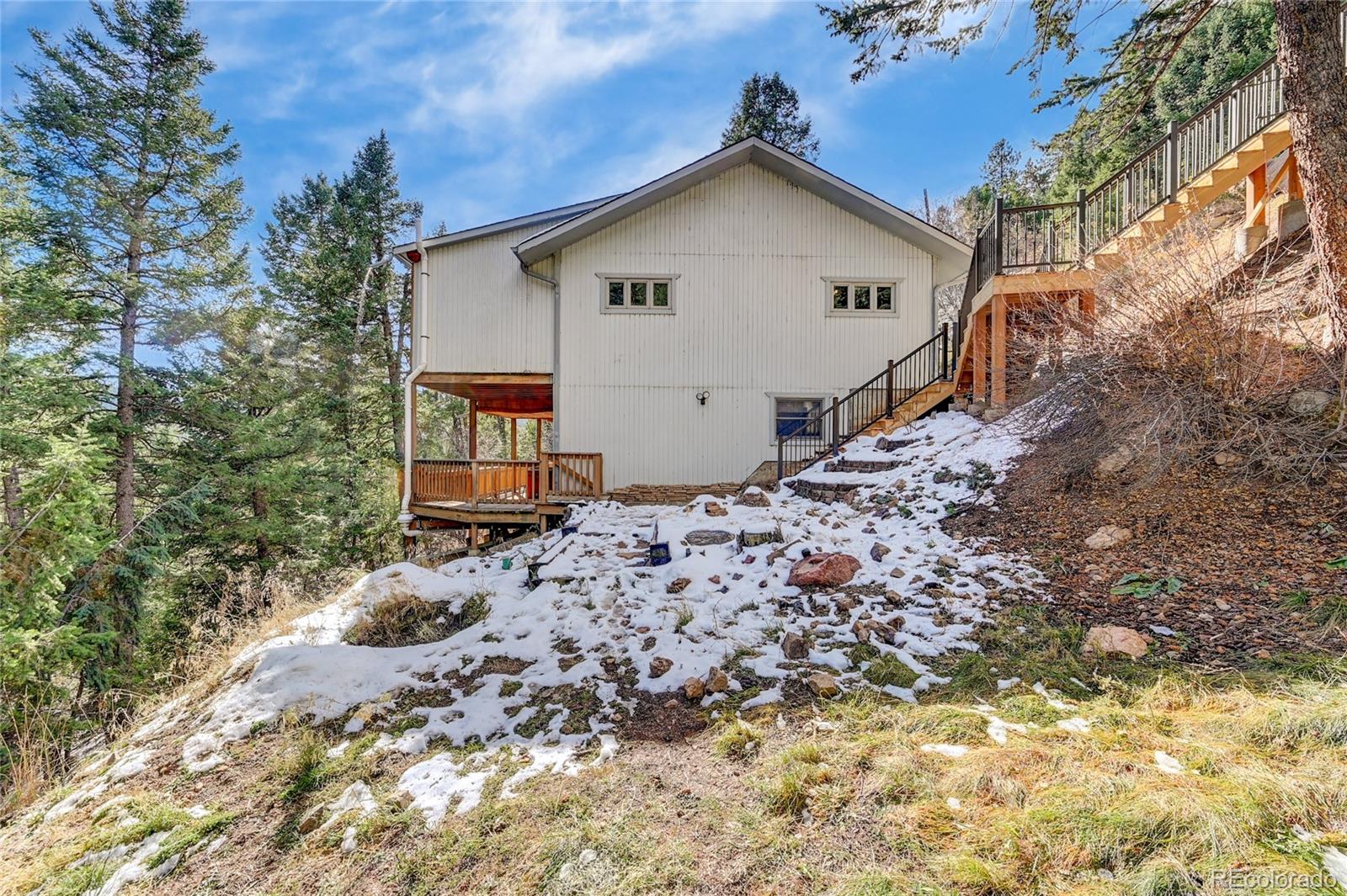 32856 Timber Ridge Road Evergreen, CO 80439 - Photo 36 of 41 a view of a house with a yard
