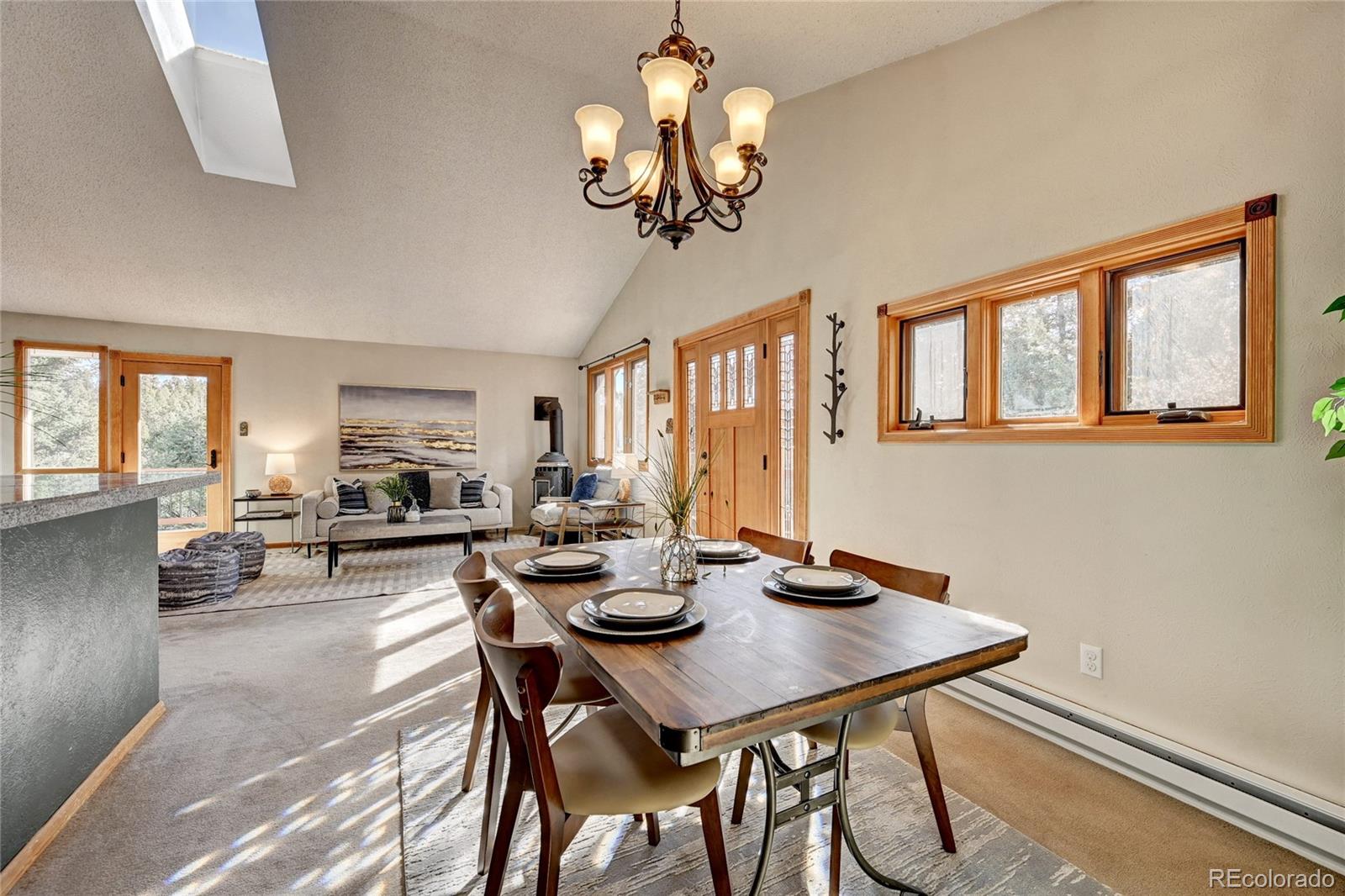 32856 Timber Ridge Road Evergreen, CO 80439 - Photo 8 of 41 a view of a dining room with furniture window and wooden floor