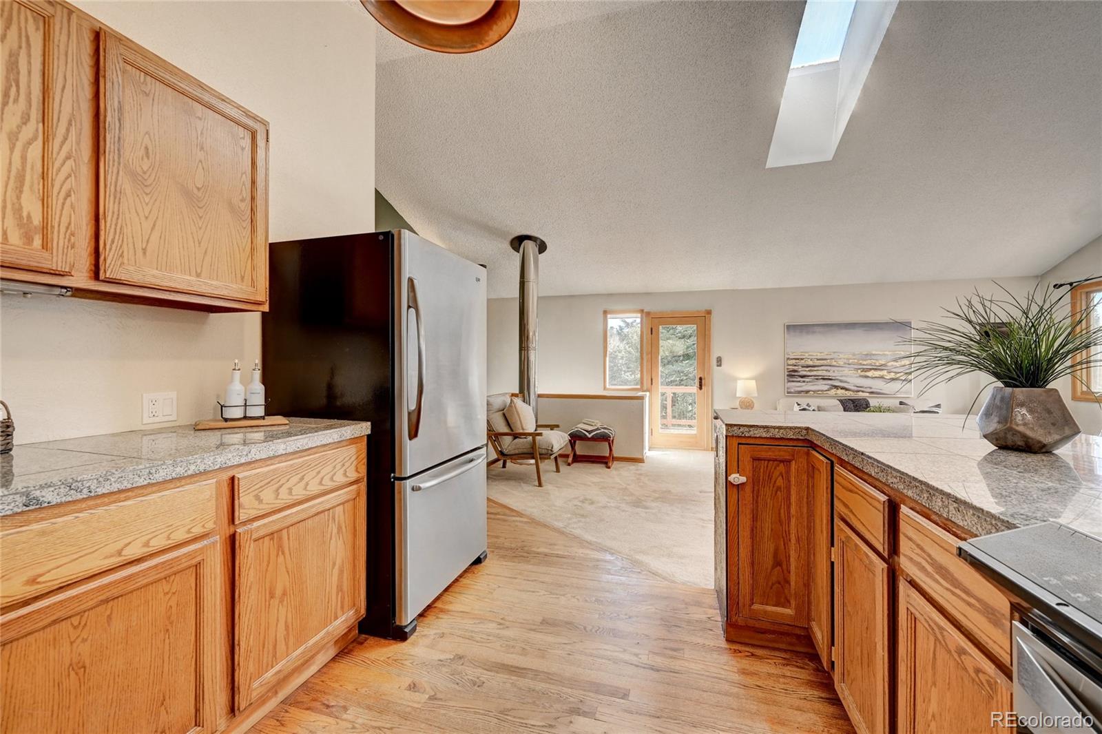 32856 Timber Ridge Road Evergreen, CO 80439 - Photo 10 of 41 a kitchen with stainless steel appliances granite countertop a refrigerator and a sink