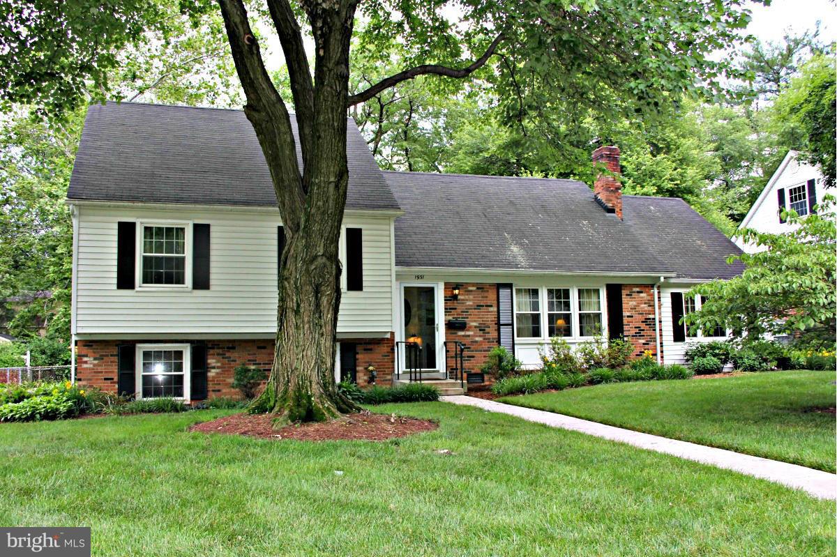 1931 Foxhall Road McLean, VA 22101 - Photo 1 of 21 a front view of a house with a yard and garage