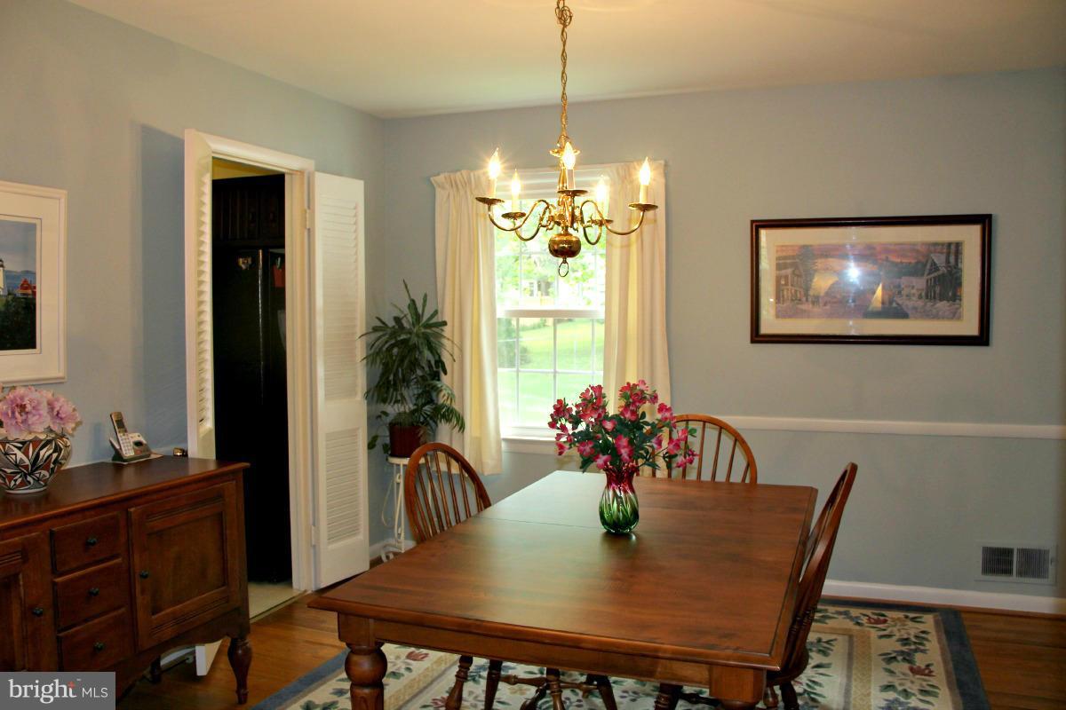 1931 Foxhall Road McLean, VA 22101 - Photo 5 of 21 a view of a dining room with furniture window and wooden floor
