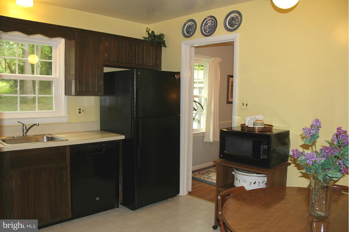 1931 Foxhall Road McLean, VA 22101 - Photo 8 of 21 a kitchen with a refrigerator and a sink