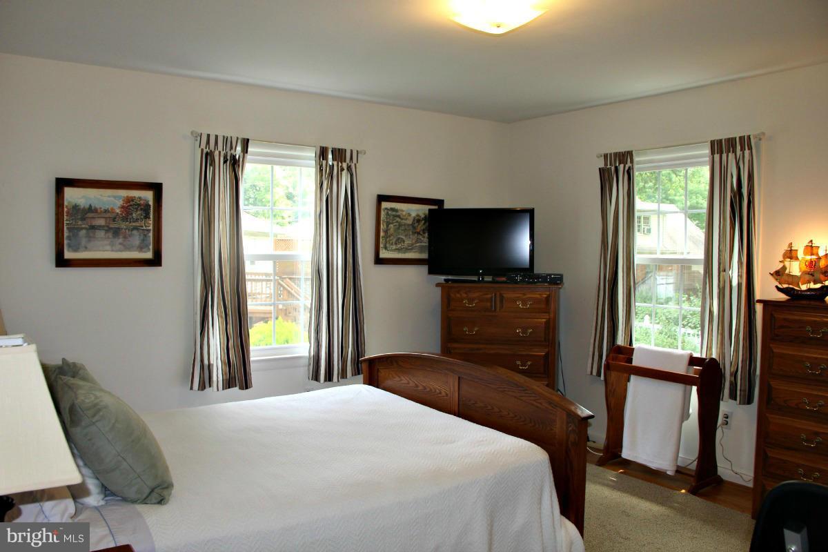 1931 Foxhall Road McLean, VA 22101 - Photo 10 of 21 a bedroom with a bed and a flat tv screen on dresser