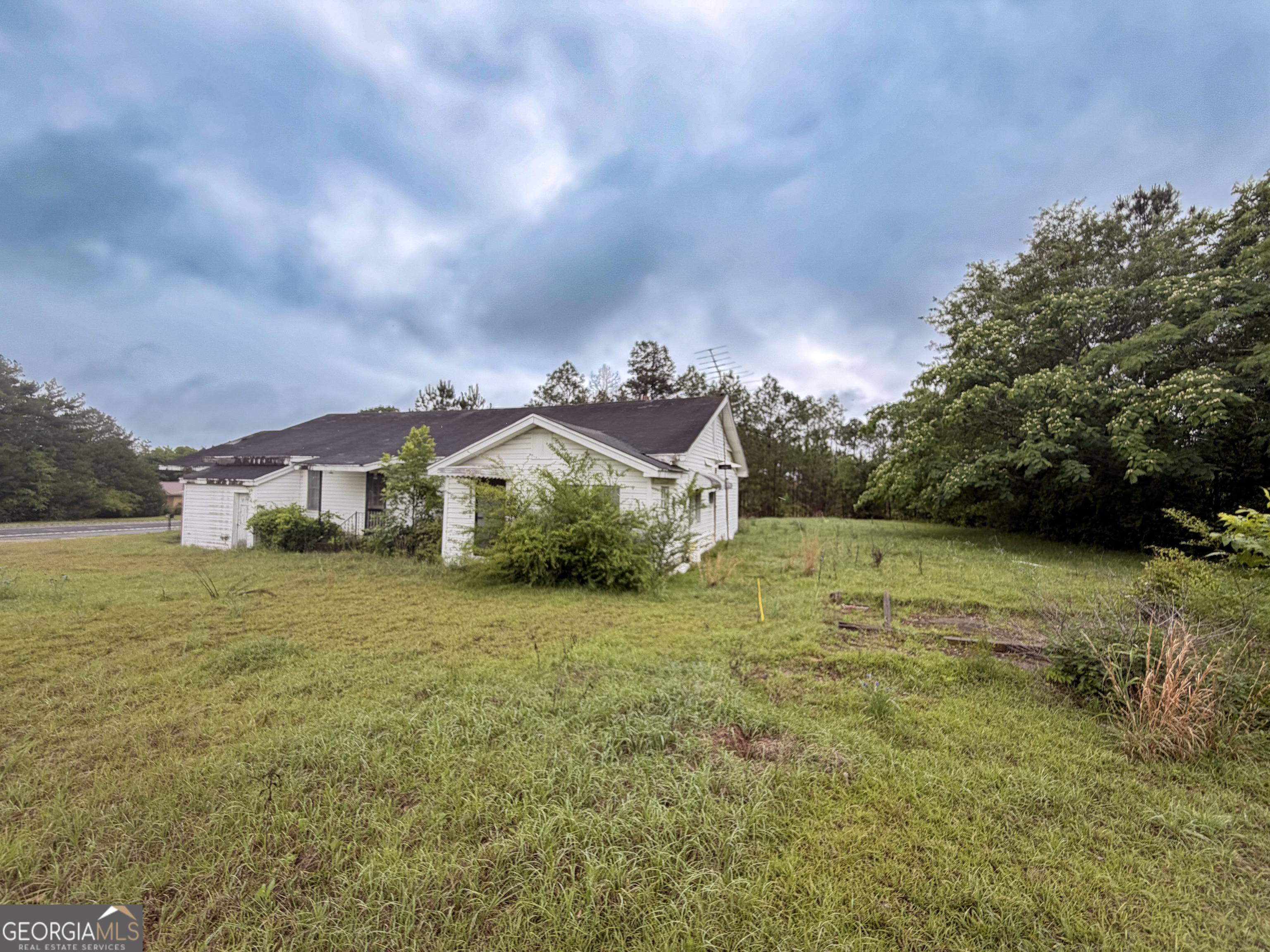 3925 Highway 441 Rentz, GA 31075 - Photo 16 of 16 a view of a big house with a big yard plants and large trees