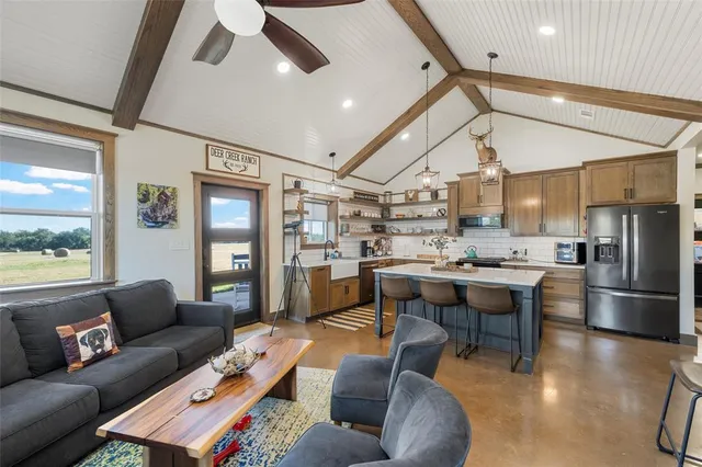 a living room with furniture and kitchen view