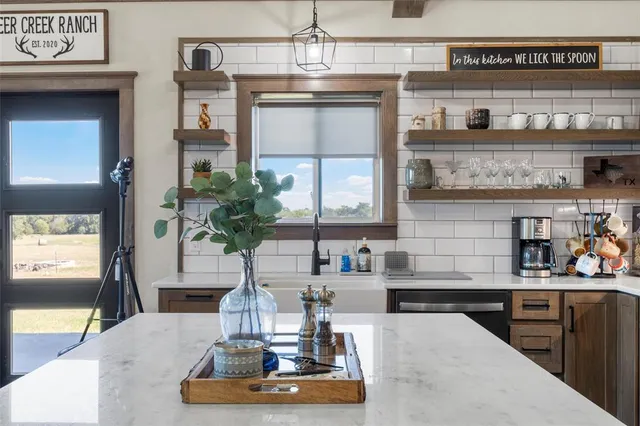 a kitchen with a refrigerator and a stove