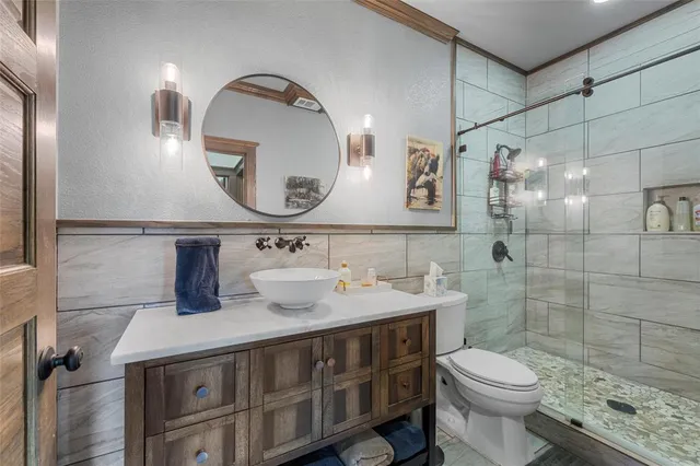 a bathroom with a sink a toilet and a mirror