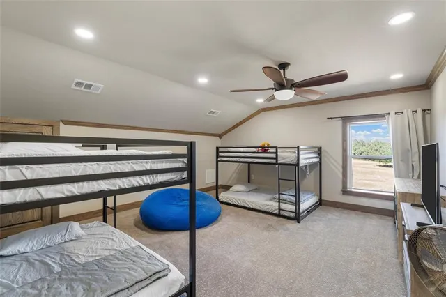 a living room with furniture a flat screen tv and a ceiling fan