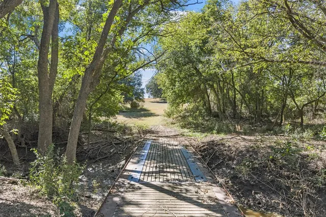 a view of a yard with wooden fence