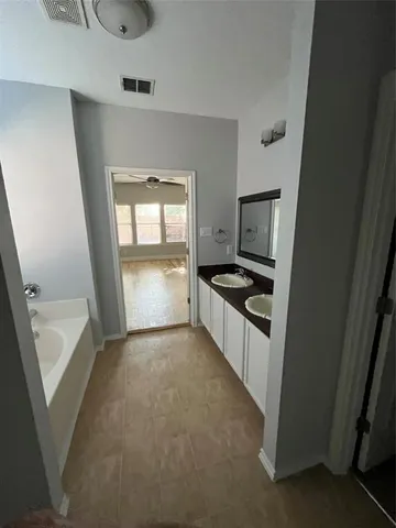 a bathroom with a granite countertop shower and a sink
