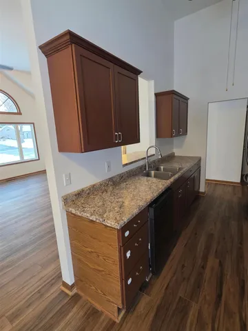a bathroom with a granite countertop sink a mirror and vanity