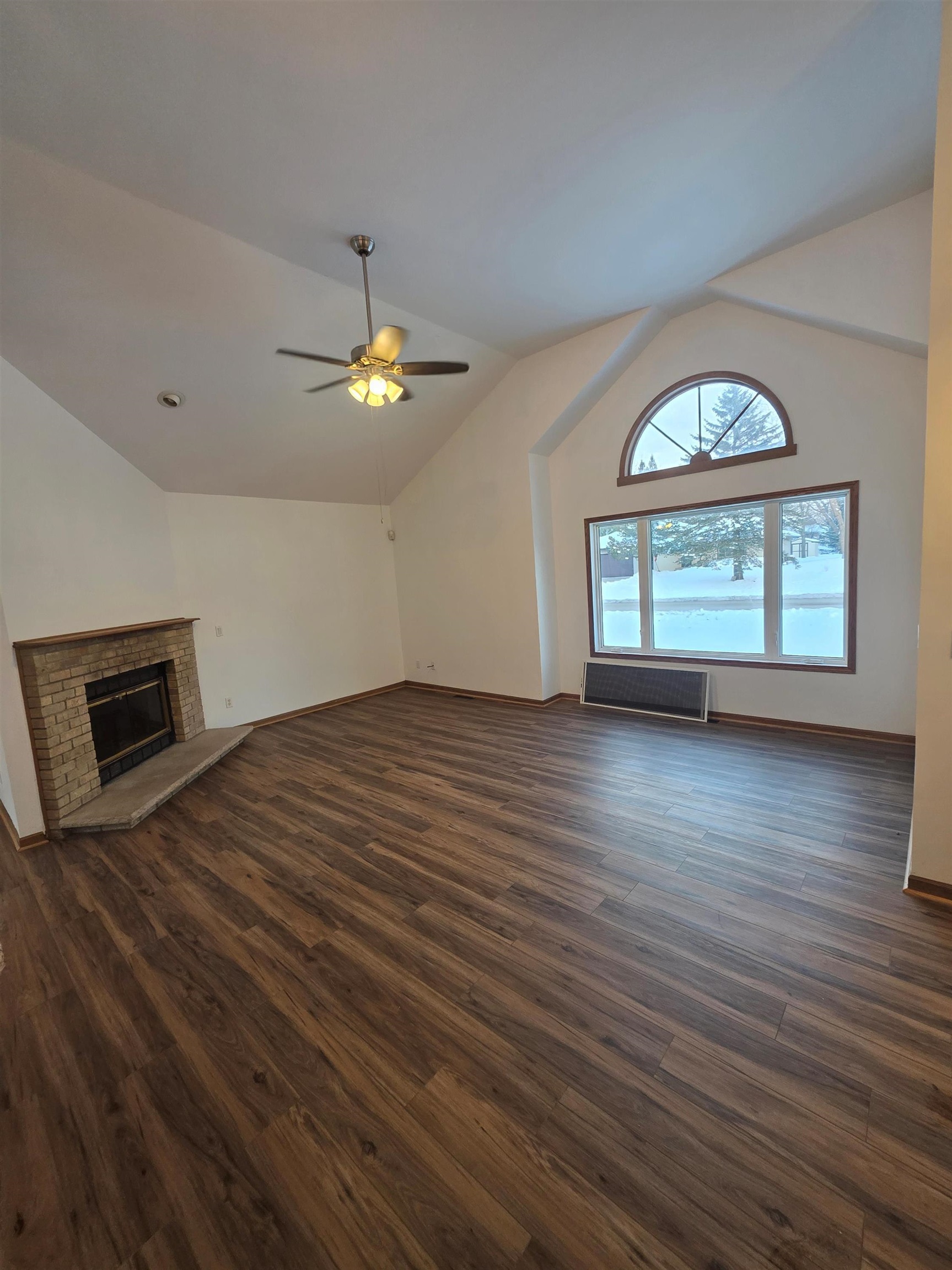 205 Gables Drive Southwest Poplar Grove, IL 61065 - Photo 19 of 33 an empty room with wooden floor chandelier fan and windows