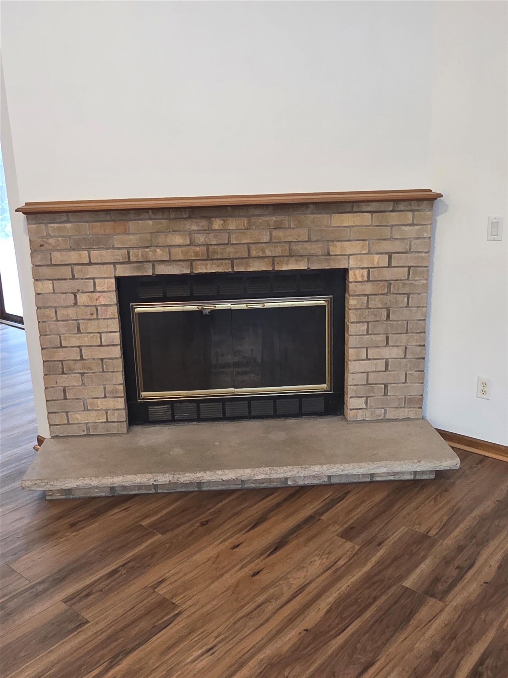 205 Gables Drive Southwest Poplar Grove, IL 61065 - Photo 21 of 33 an empty room with wooden floor and fireplace