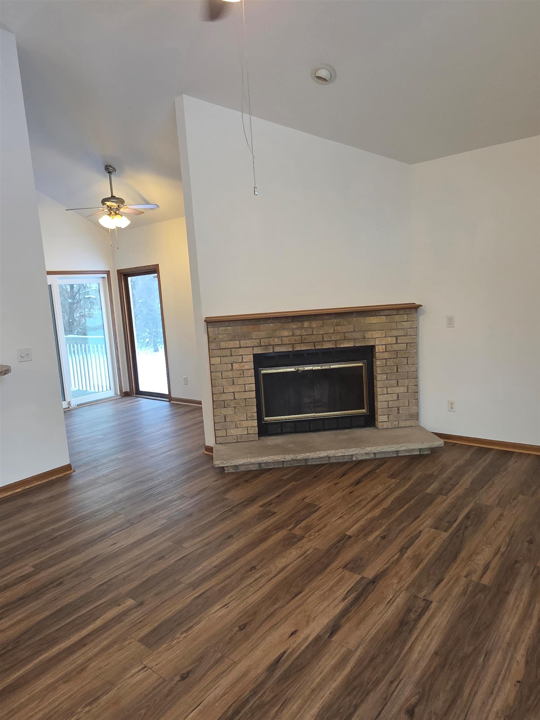 205 Gables Drive Southwest Poplar Grove, IL 61065 - Photo 22 of 33 a view of an empty room with wooden floor and fireplace