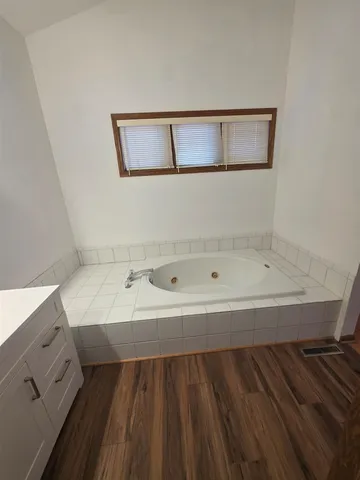 a bathroom with a bathtub and a sink