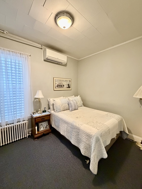 176 M Street, Unit 1 Boston, MA 02127 - Photo 8 of 11 a bed sitting in a bedroom next to a window