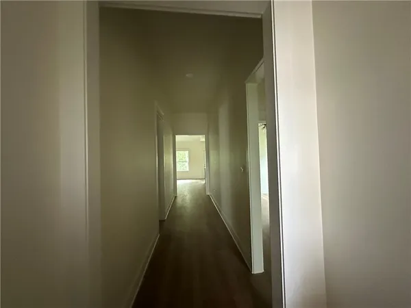 a view of a hallway with a wooden floor