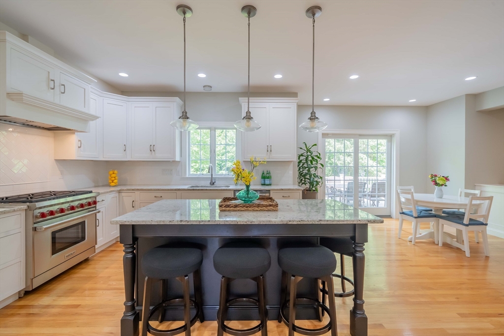 15 Hickory Street Lexington, MA 02421 - Photo 11 of 42 a kitchen with granite countertop wooden floor and stainless steel appliances