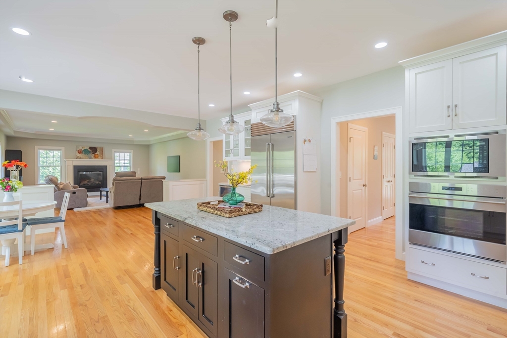 15 Hickory Street Lexington, MA 02421 - Photo 15 of 42 a kitchen with stainless steel appliances granite countertop a kitchen island a stove and a sink