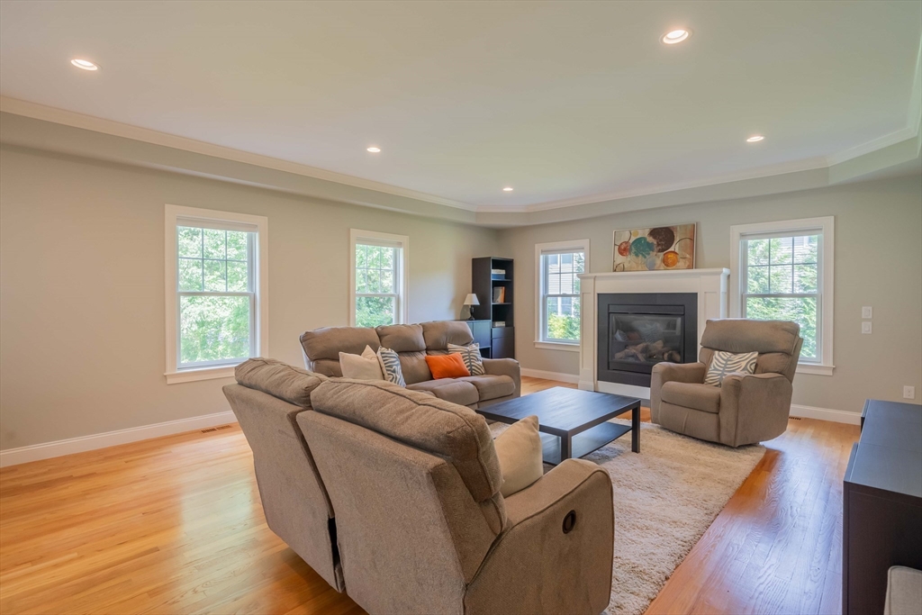 15 Hickory Street Lexington, MA 02421 - Photo 18 of 42 a living room with furniture flat screen tv and a fireplace