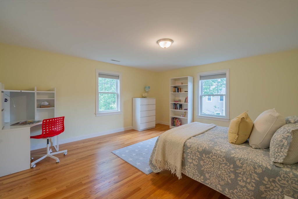 15 Hickory Street Lexington, MA 02421 - Photo 29 of 42 a bedroom with a bed and wooden floor