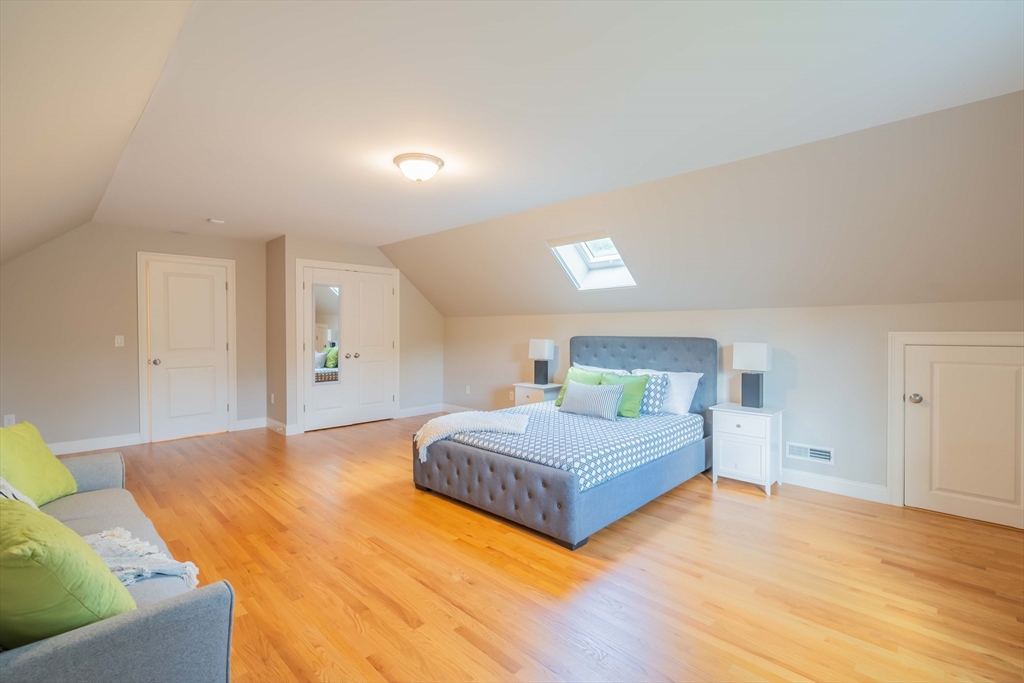 15 Hickory Street Lexington, MA 02421 - Photo 38 of 42 a spacious bedroom with a bed and a couch