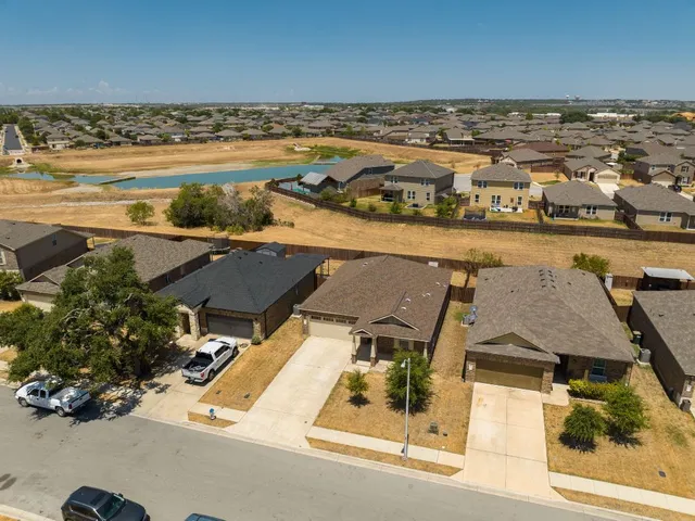 an aerial view of residential houses with outdoor space