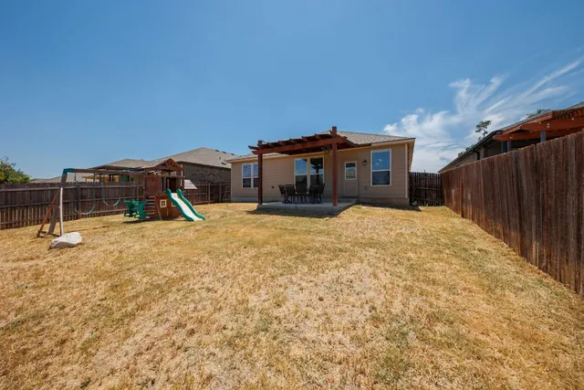 a view of a house with a backyard