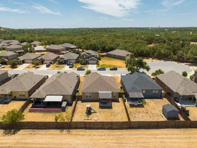 an aerial view of residential houses with outdoor space
