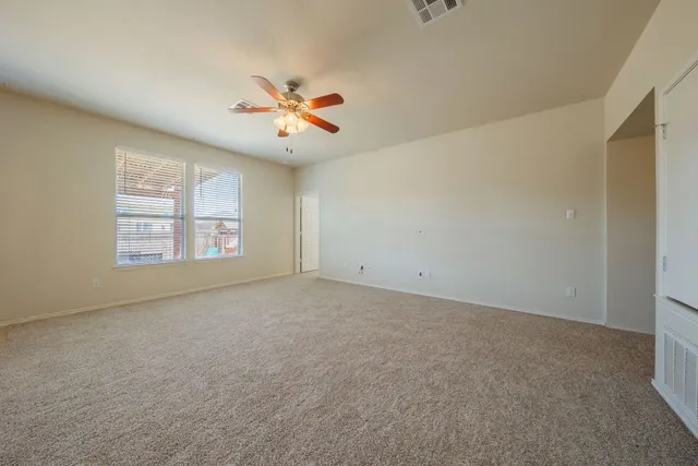 a view of a livingroom with a ceiling fan and window