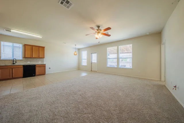 a view of a kitchen with a sink dishwasher and a fireplace