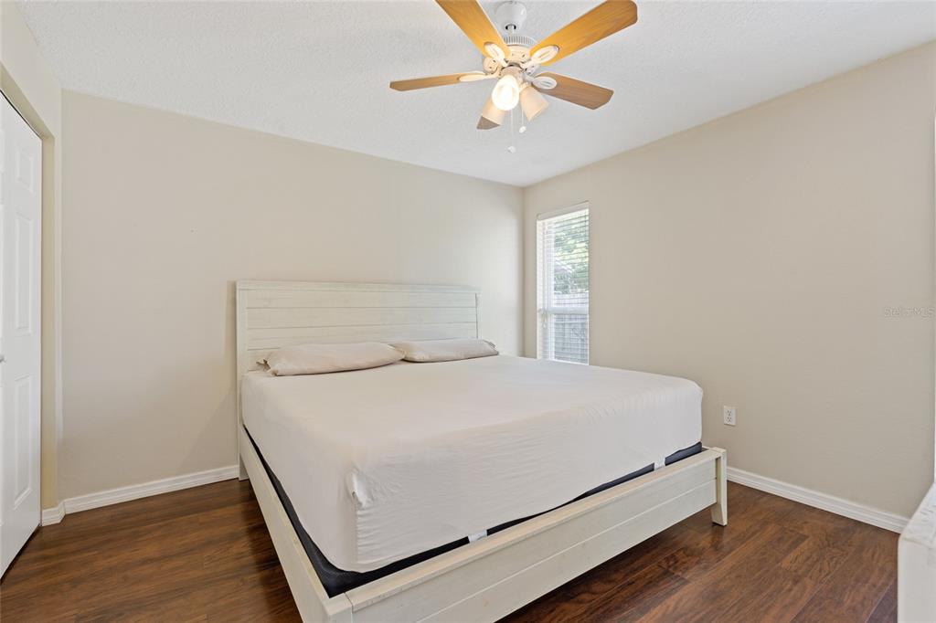 7651 Montague Loop New Port Richey, FL 34655 - Photo 14 of 26 a room with a bed and a ceiling fan