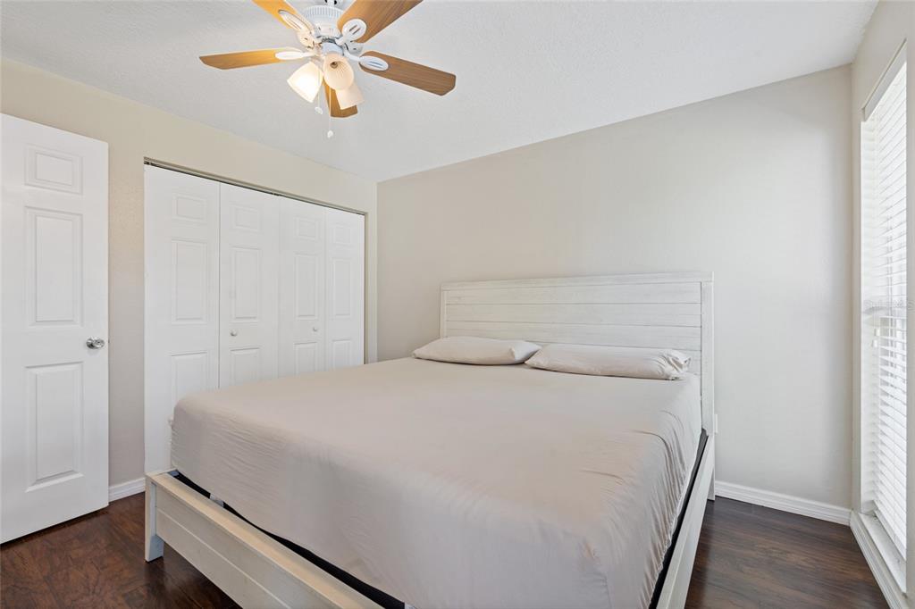 7651 Montague Loop New Port Richey, FL 34655 - Photo 16 of 26 a bedroom with a bed and a chandelier