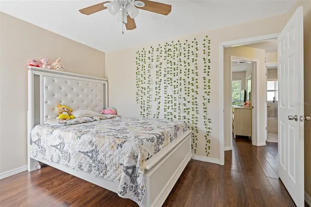 a bed sitting in a bedroom next to a bathroom