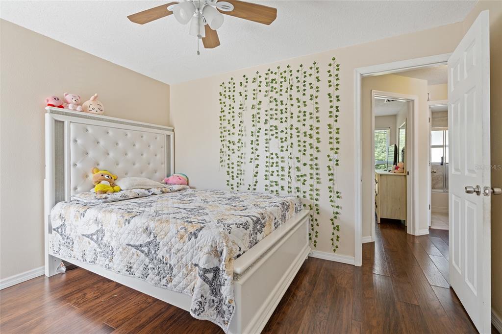 7651 Montague Loop New Port Richey, FL 34655 - Photo 17 of 26 a bed sitting in a bedroom next to a bathroom