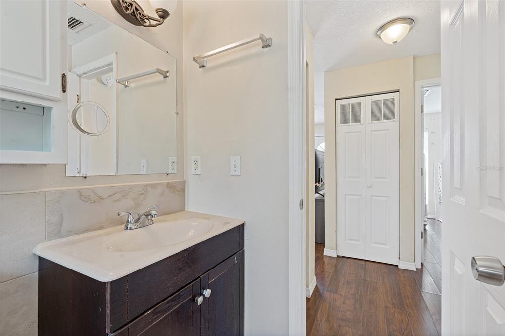 7651 Montague Loop New Port Richey, FL 34655 - Photo 21 of 26 a bathroom with a sink mirror and a shower