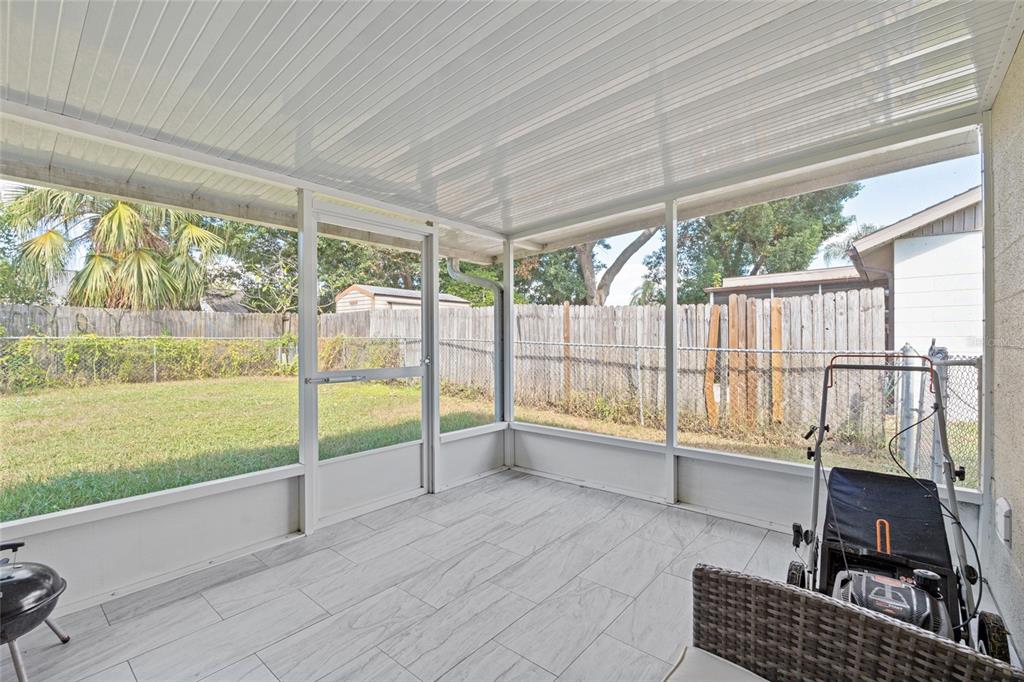 7651 Montague Loop New Port Richey, FL 34655 - Photo 23 of 26 a view of a living room and floor to ceiling window