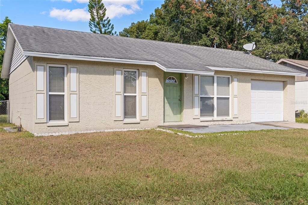 7651 Montague Loop New Port Richey, FL 34655 - Photo 8 of 26 a front view of a house with a garden