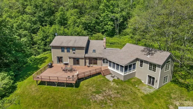 aerial view of a house with a garden and a trees