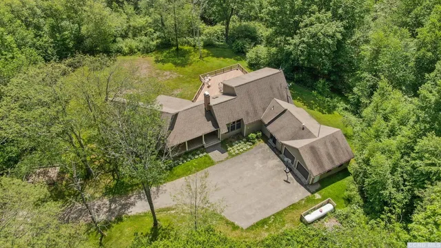 an aerial view of a house with a yard and lake view