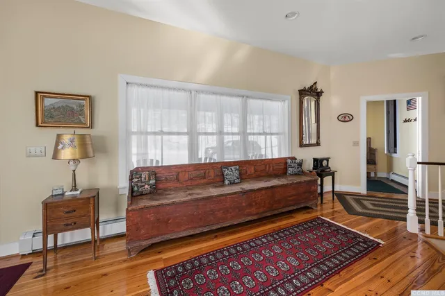a bedroom with furniture and a rug