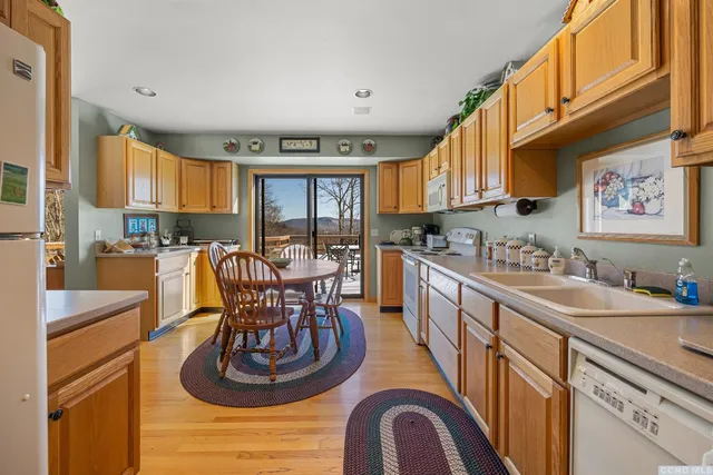 a large kitchen with a large window and stainless steel appliances