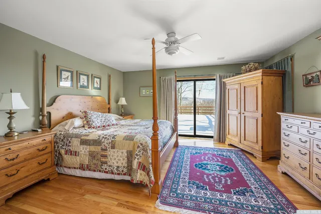 a bedroom with a large bed and a dresser