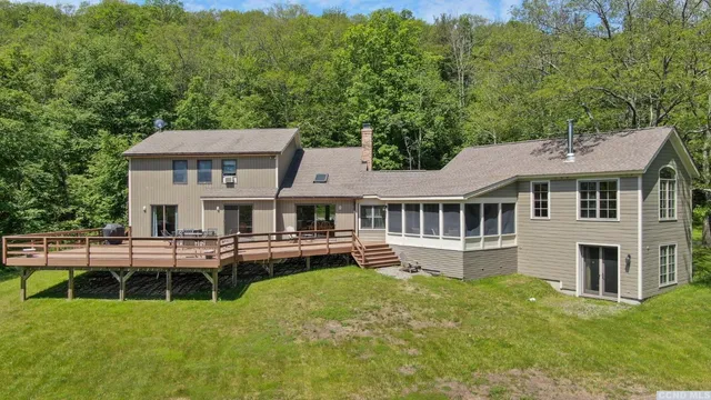 a aerial view of a house with a yard table and chairs