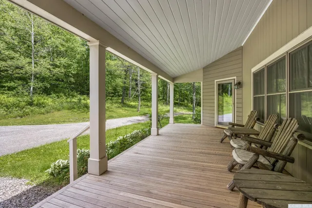 a balcony with furniture and garden view