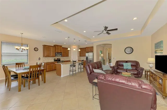 a view of a dining room with furniture and a chandelier