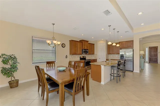 a kitchen with granite countertop a sink dishwasher stove and cabinets