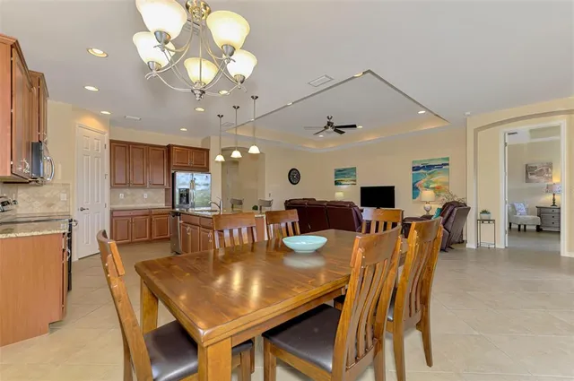a large kitchen with kitchen island a sink stainless steel appliances and furniture